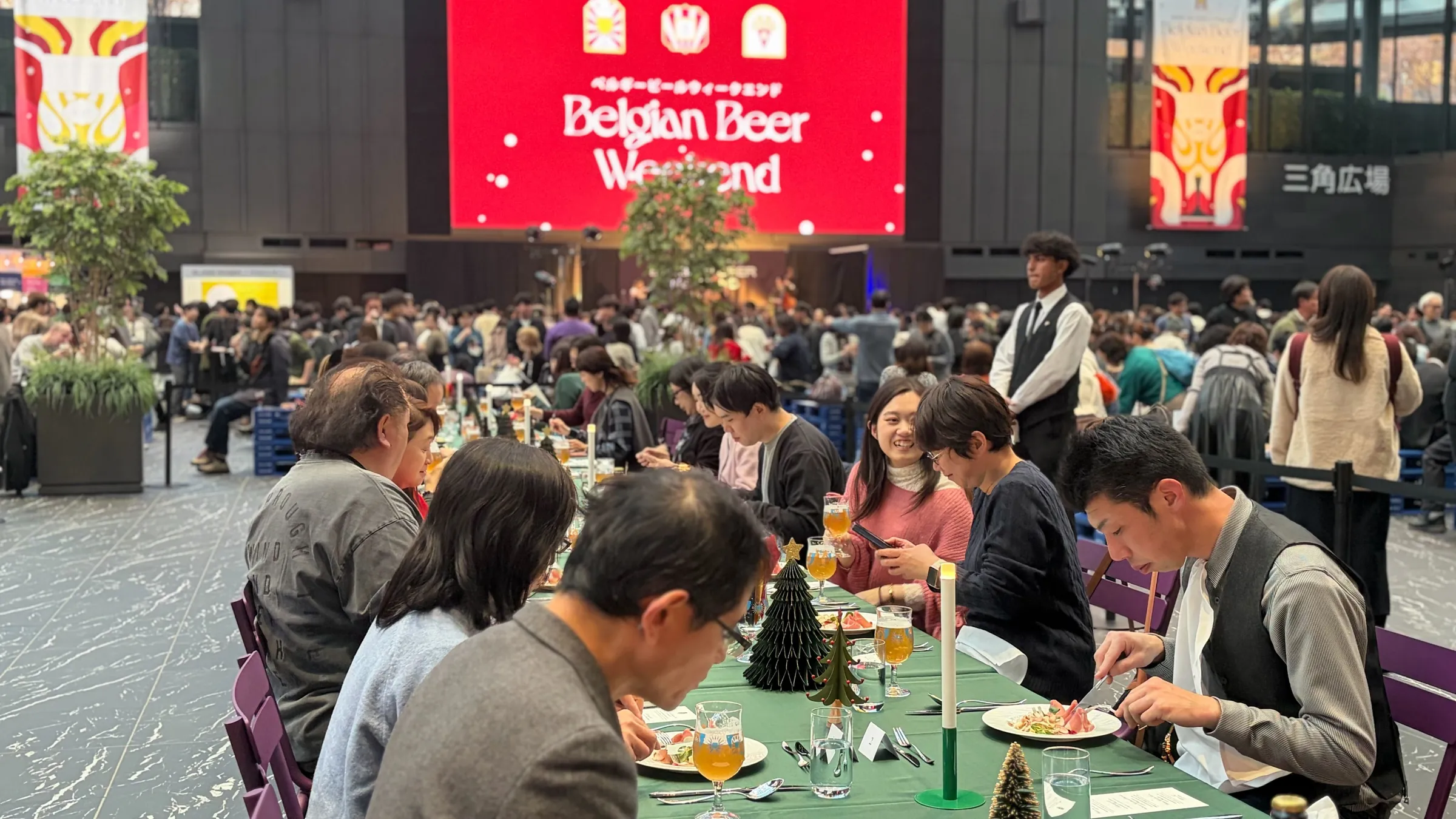Guests seated along the communal table mid-dinner at Shinjuku 2025