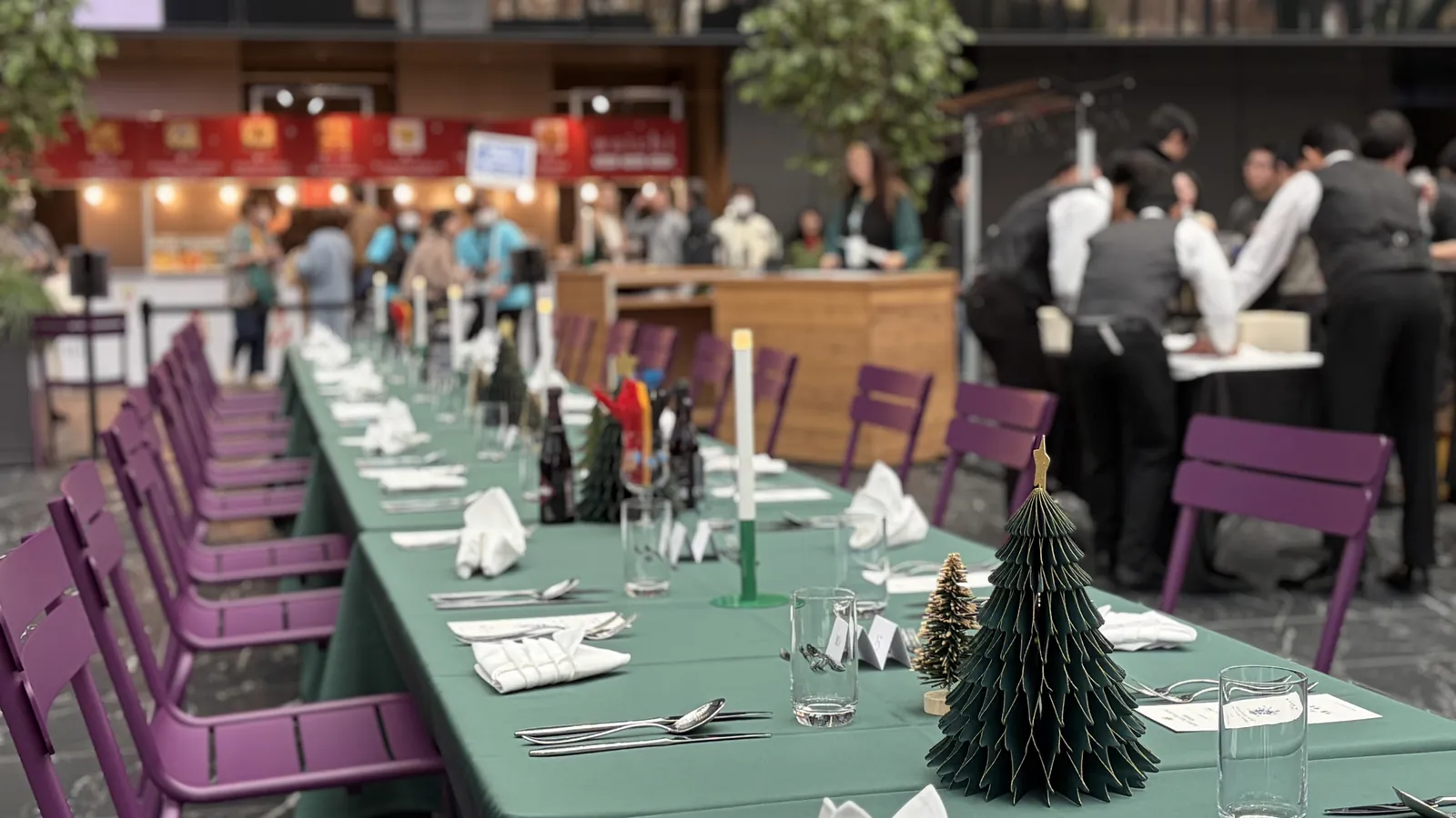 The full length of the communal table, set and waiting for guests